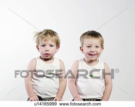 Twin boys sitting together View Large Photo Image Stock Photo - Twin boys sitting together. Fotosearch