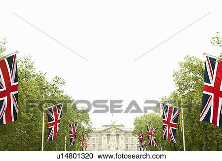 Stock Image - Union Jack flags and Buckingham Palace. Fotosearch