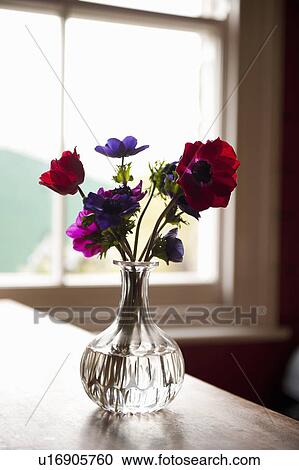 Stock Image - Vase of flowers on table. Fotosearch