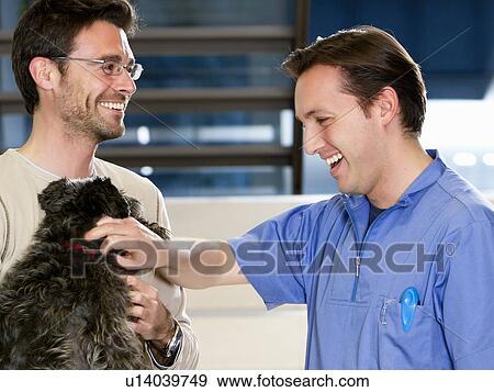 Stock Photo - Vet talking to man with his dog. Fotosearch