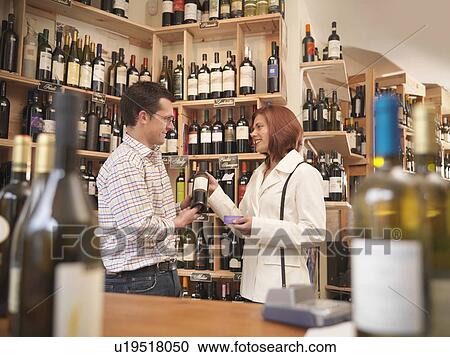Wine merchant with customer in shop View Large Photo Image Stock Image - Wine merchant with customer in shop. Fotosearch