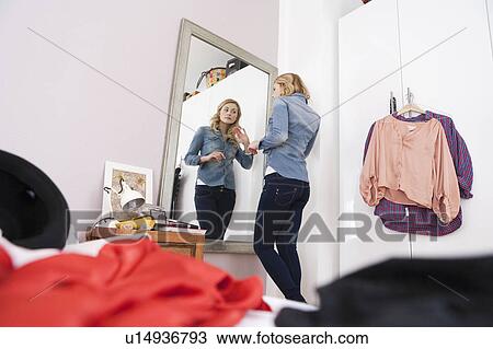 Woman admiring herself in mirror View Large Photo Image Stock Image - Woman admiring herself in mirror. Fotosearch