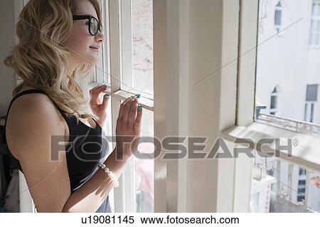 Woman admiring scenery outside window View Large Photo Image Stock Photography - Woman admiring scenery outside window. Fotosearch