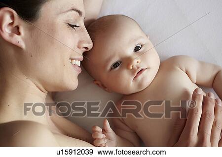 Woman and baby laying in bed View Large Photo Image Stock Photo - Woman and baby laying in bed. Fotosearch