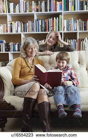 Woman and grandchildren reading together View Large Photo Image Stock Image - Woman and grandchildren reading together. Fotosearch