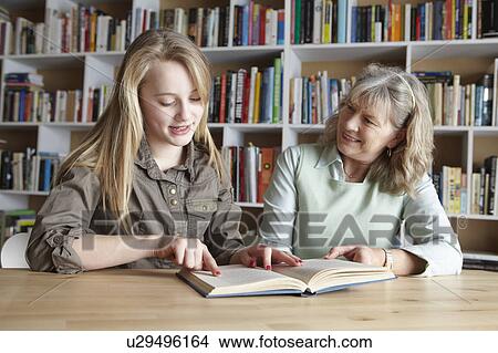 Woman and granddaughter reading together View Large Photo Image Picture - Woman and granddaughter reading together. Fotosearch