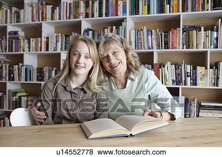 Woman and granddaughter reading together View Large Photo Image Stock Photo - Woman and granddaughter reading together. Fotosearch