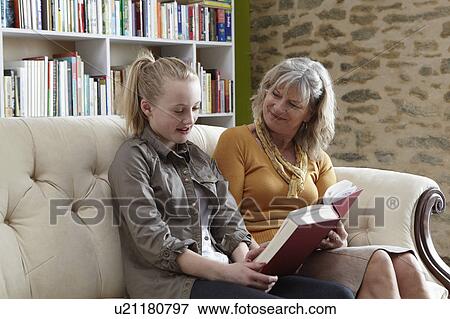 Woman and granddaughter reading together View Large Photo Image Stock Photo - Woman and granddaughter reading together. Fotosearch
