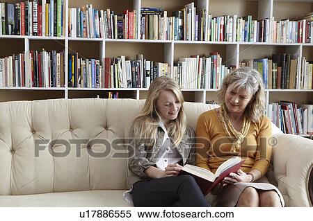 Woman and granddaughter reading together View Large Photo Image Stock Photography - Woman and granddaughter reading together. Fotosearch