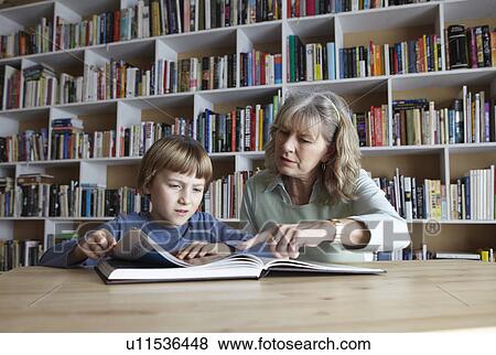 Stock Photo - Woman and grandson reading together. Fotosearch