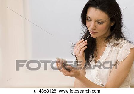 Woman applying make up View Large Photo Image Stock Photo - Woman applying make up. Fotosearch