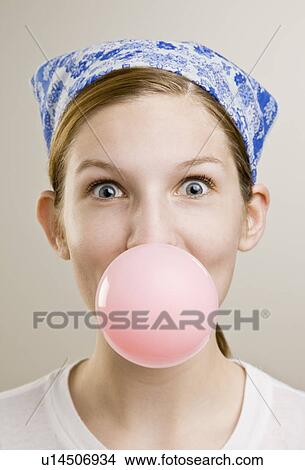 Woman blowing a bubble with gum View Large Photo Image Picture - Woman blowing a bubble with gum. Fotosearch