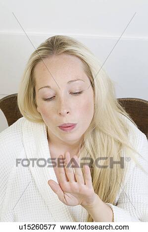Stock Photo - Woman blowing her nail polish dry. Fotosearch