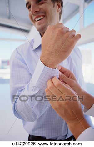 Woman buttoning businessman’s cuffs View Large Photo Image Stock Photograph - Woman buttoning businessman’s cuffs. Fotosearch