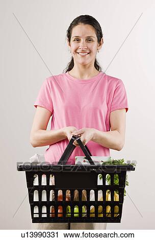 Woman carrying basket of groceries View Large Photo Image Stock Image - Woman carrying basket of groceries. Fotosearch