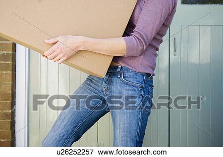 Woman carrying cardboard box View Large Photo Image Stock Photo - Woman carrying cardboard box. Fotosearch
