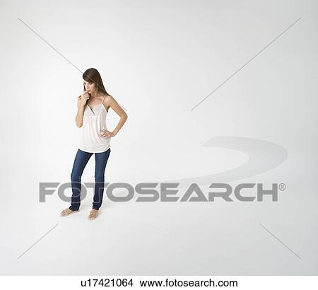 Picture - Woman casting question mark shadow. Fotosearch