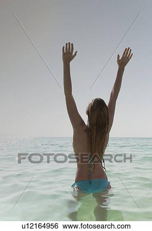 Woman cheering in water View Large Photo Image Stock Photograph - Woman cheering in water. Fotosearch