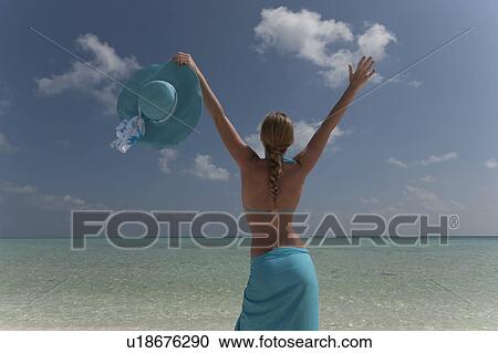 Woman cheering on tropical beach View Large Photo Image Stock Image - Woman cheering on tropical beach. Fotosearch