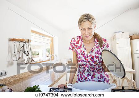 Woman cooking in kitchen View Large Photo Image Picture - Woman cooking in kitchen. Fotosearch