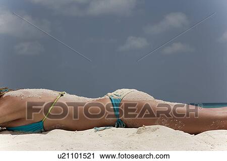 Woman covered in sand laying on beach View Large Photo Image Stock Image - Woman covered in sand laying on beach. Fotosearch