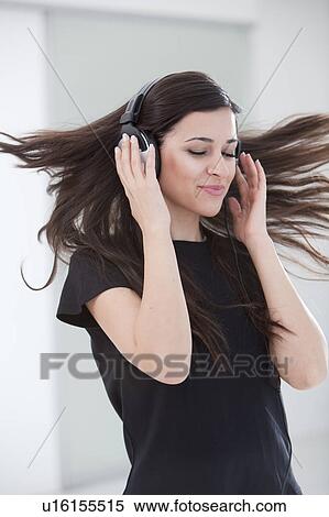 Woman dancing in headphones View Large Photo Image Stock Photography - Woman dancing in headphones. Fotosearch
