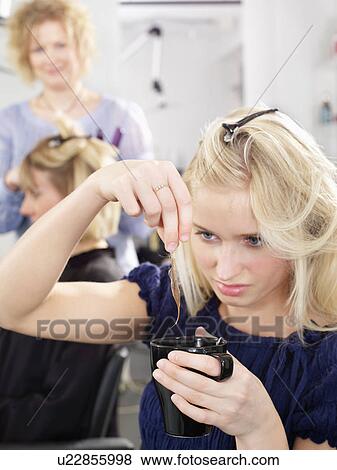 Stock Photo - Woman dipping hair into cup of coffee. Fotosearch