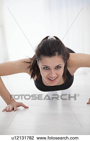 Woman doing push-ups View Large Photo Image Stock Image - Woman doing push-ups. Fotosearch