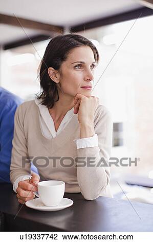 Woman drinking coffee at cafe View Large Photo Image Stock Image - Woman drinking coffee at cafe. Fotosearch