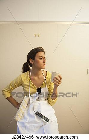 Woman drinking coffee during decorating View Large Photo Image Stock Photograph - Woman drinking coffee during decorating. Fotosearch