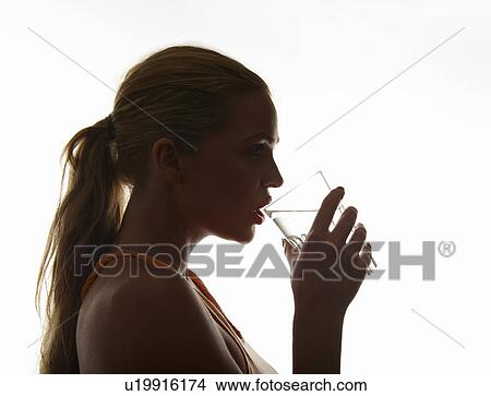 Picture - Woman drinking glass of water. Fotosearch