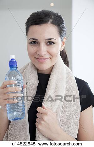 Stock Photography - Woman drinking water after workout. Fotosearch