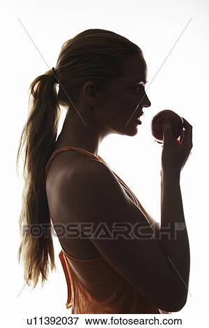 Stock Photo - Woman eating an apple. Fotosearch