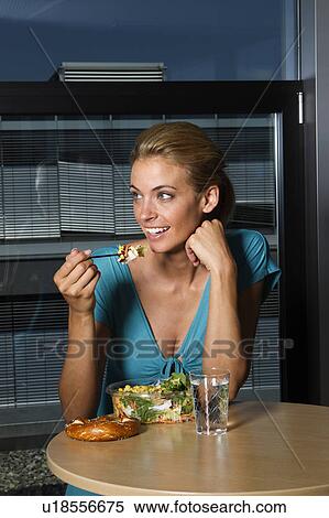 Woman eating lunch in office View Large Photo Image Stock Photography - Woman eating lunch in office. Fotosearch