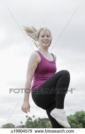 Stock Photo - Woman exercising outdoors. Fotosearch
