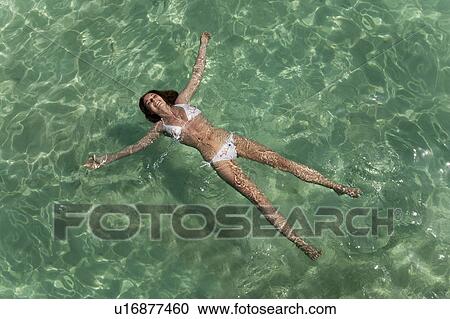 Woman floating in tropical sea View Large Photo Image Stock Image - Woman floating in tropical sea. Fotosearch