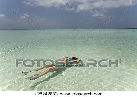 Woman floating in tropical sea View Large Photo Image Stock Image - Woman floating in tropical sea. Fotosearch