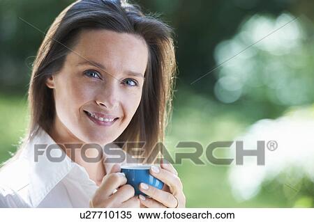 Woman having cup of coffee outdoors View Large Photo Image Stock Photography - Woman having cup of coffee outdoors. Fotosearch