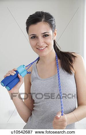 Woman holding jump rope View Large Photo Image Stock Photo - Woman holding jump rope. Fotosearch