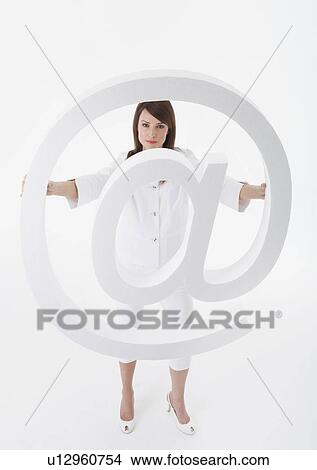 Woman holding large ‘@’ symbol View Large Photo Image Picture - Woman holding large ‘@’ symbol. Fotosearch