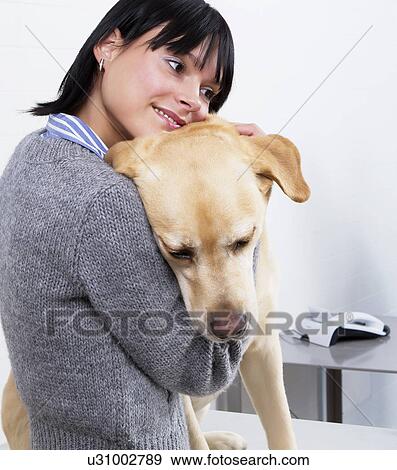 Woman hugging a dog View Large Photo Image Stock Photo - Woman hugging a dog. Fotosearch