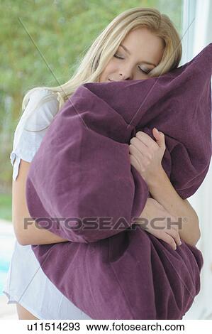 Woman hugging pillow at home View Large Photo Image Stock Image - Woman hugging pillow at home. Fotosearch