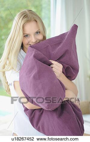 Woman hugging pillow at home View Large Photo Image Stock Image - Woman hugging pillow at home. Fotosearch