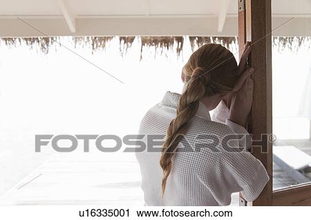 Woman in bathrobe standing at door View Large Photo Image Stock Image - Woman in bathrobe standing at door. Fotosearch