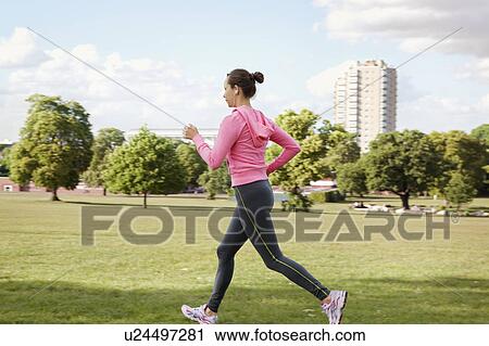 Woman jogging in park View Large Photo Image Stock Image - Woman jogging in park. Fotosearch