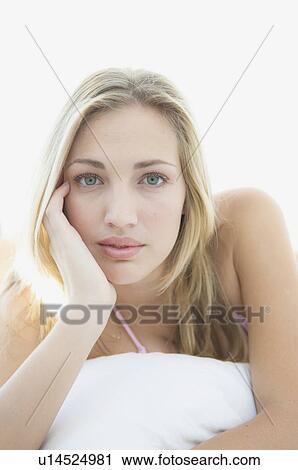 Stock Image - Woman laying in bed. Fotosearch