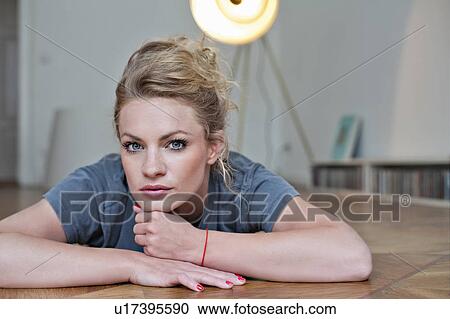 Woman laying on floor View Large Photo Image Stock Image - Woman laying on floor. Fotosearch