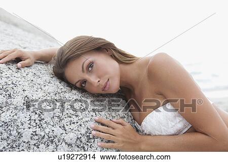 Woman laying on stone View Large Photo Image Picture - Woman laying on stone. Fotosearch