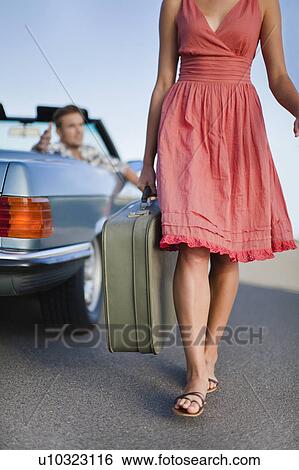 Woman leaving man in convertible View Large Photo Image Stock Photograph - Woman leaving man in convertible. Fotosearch