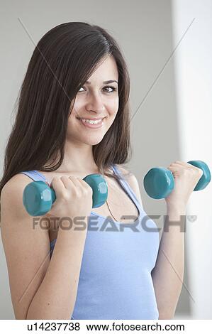 Woman lifting hand weights View Large Photo Image Stock Photo - Woman lifting hand weights. Fotosearch